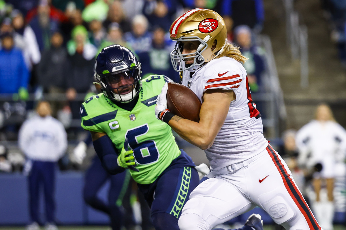 San Francisco 49ers tight end George Kittle (85) runs for a touchdown against Seattle Seahawks safety Quandre Diggs (6) after making a reception during the first quarter at Lumen Field.